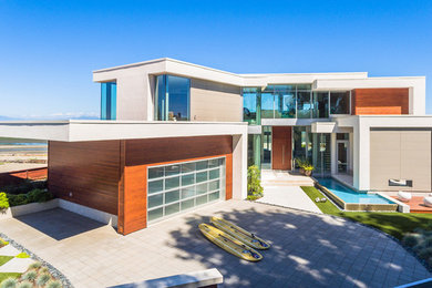 Example of a large minimalist multicolored two-story mixed siding exterior home design in Vancouver with a mixed material roof