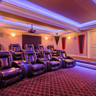 Inspiration for a large timeless enclosed carpeted home theater remodel in St Louis with beige walls and a media wall