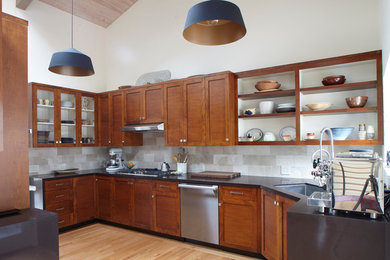 Mid-sized trendy l-shaped bamboo floor and brown floor eat-in kitchen photo in San Francisco with an undermount sink, shaker cabinets, medium tone wood cabinets, white backsplash, stone tile backsplash, stainless steel appliances and no island
