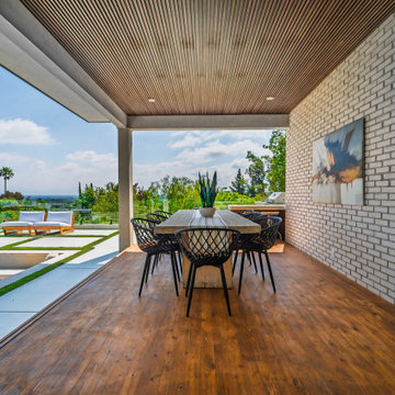 Outdoor Dining Room Framed by Brick and Timber