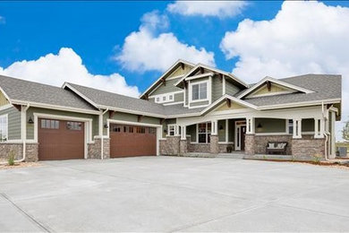 Example of a large country green two-story mixed siding gable roof design in Denver