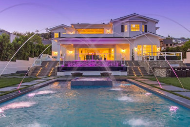 Example of a large trendy backyard concrete and rectangular natural pool fountain design in Los Angeles