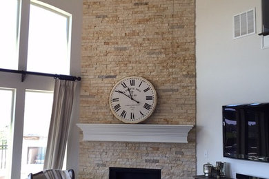 Family room - small southwestern enclosed dark wood floor family room idea in Dallas with white walls, a standard fireplace, a stone fireplace and no tv