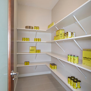 Large contemporary kitchen pantry designs - Inspiration for a large contemporary l-shaped ceramic floor kitchen pantry remodel in Edmonton with an undermount sink, flat-panel cabinets, dark wood cabinets, granite countertops, multicolored backsplash, glass tile backsplash, stainless steel appliances and an island