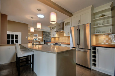 Mid-sized transitional galley porcelain tile enclosed kitchen photo in Ottawa with an undermount sink, shaker cabinets, white cabinets, wood countertops, gray backsplash, subway tile backsplash and stainless steel appliances