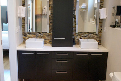 Alcove shower - mid-sized modern master multicolored tile and glass tile light wood floor alcove shower idea in Denver with flat-panel cabinets, dark wood cabinets, a one-piece toilet, gray walls, a vessel sink and quartz countertops
