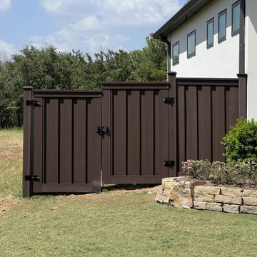 Dark Brown Composite Trex Fence and Black Iron Fence