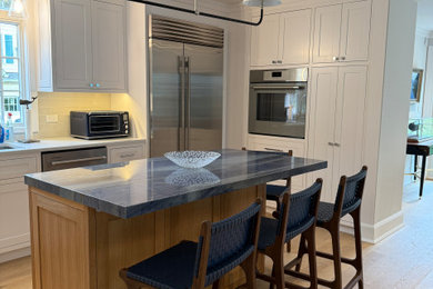 Transitional light wood floor kitchen photo in New York with quartzite countertops, beige backsplash, subway tile backsplash, stainless steel appliances and blue countertops
