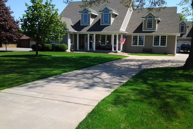 Large traditional brown two-story wood gable roof idea in Other