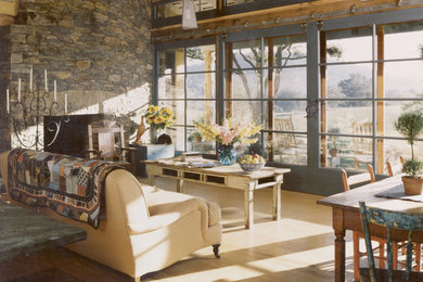 Mid-sized farmhouse open concept light wood floor living room library photo in DC Metro with a standard fireplace and a stone fireplace
