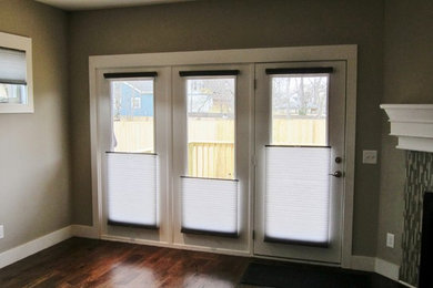 Example of a mid-sized trendy enclosed dark wood floor family room design in Nashville with gray walls, a standard fireplace and a tile fireplace