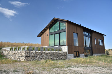 Mid-sized minimalist brown two-story wood exterior home photo with a shingle roof and a black roof