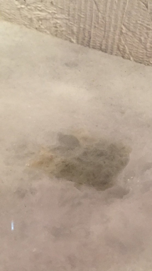 Spots in white granite turning yellow brown