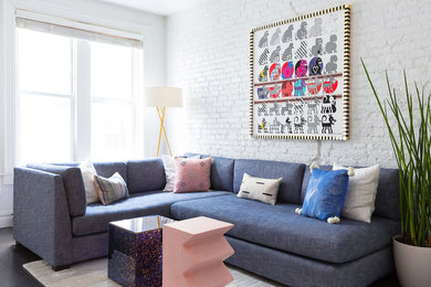 Small trendy dark wood floor and brown floor living room photo in New York with white walls and no fireplace