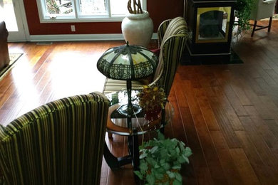 Inspiration for a transitional medium tone wood floor living room remodel in Other