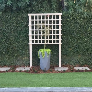 Putting green, artificial turf, outdoor kitchen, custom trellis,