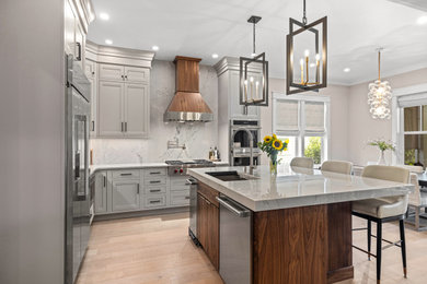 Eat-in kitchen - mid-sized transitional l-shaped light wood floor eat-in kitchen idea in Other with an undermount sink, flat-panel cabinets, medium tone wood cabinets, quartzite countertops, gray backsplash, stone slab backsplash, stainless steel appliances, an island and gray countertops