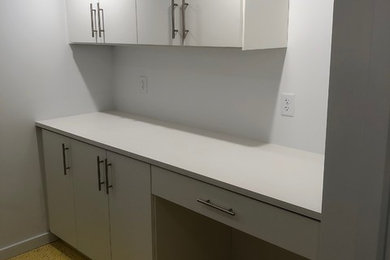 Utility room - small modern galley concrete floor and yellow floor utility room idea in Other with an utility sink, flat-panel cabinets, white cabinets, laminate countertops, white walls, a side-by-side washer/dryer and white countertops