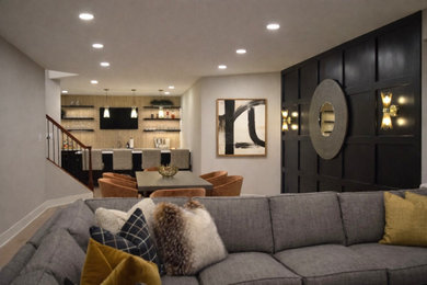 Large minimalist walk-out laminate floor and brown floor basement photo in DC Metro with a bar, black walls, a standard fireplace and a stone fireplace