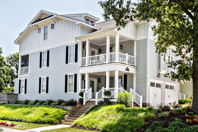 Inspiration for a large timeless blue three-story mixed siding gable roof remodel in Other
