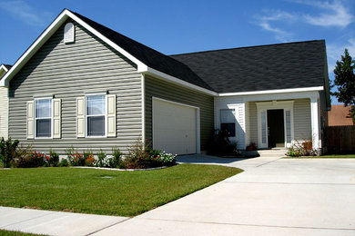 Inspiration for a small timeless yellow two-story wood exterior home remodel in New Orleans with a shingle roof