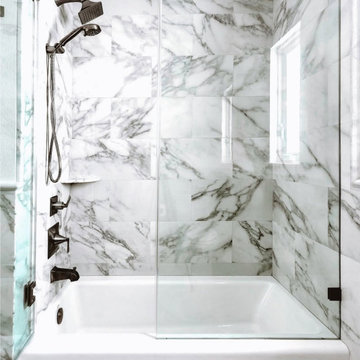 Sophisticated Marble Bathroom With Frameless Glass Shower and Luxury Finishes
