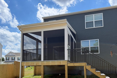 Mid-sized trendy screened-in and metal railing porch photo in Other