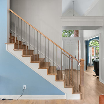 Modern transitional staircase with natural oak treads and slim metal balusters