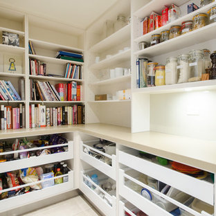This is an example of a large contemporary u-shaped kitchen pantry in Melbourne with a single-bowl sink, open cabinets, white cabinets, quartz benchtops, white splashback, glass sheet splashback, stainless steel appliances, porcelain floors, with island and beige floor.