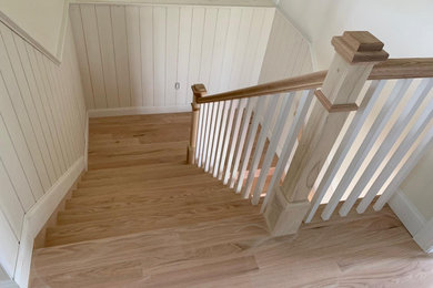 Inspiration for a wooden u-shaped wood railing and shiplap wall staircase remodel in New York with wooden risers