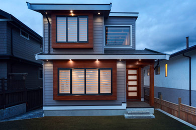 Example of a transitional home design design in Vancouver