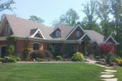 Inspiration for a beige two-story brick exterior home remodel in Indianapolis