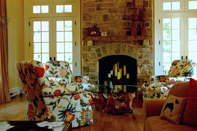 Family room - mid-sized eclectic enclosed medium tone wood floor family room idea in Richmond with a standard fireplace and a stone fireplace