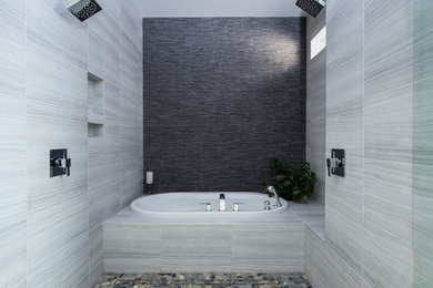 Large transitional master gray tile drop-in bathtub photo in Vancouver with flat-panel cabinets, dark wood cabinets, a one-piece toilet, white walls, a drop-in sink and quartz countertops