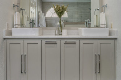 Inspiration for a small contemporary master bathroom in Dallas with shaker cabinets, grey cabinets, an open shower, a two-piece toilet, gray tile, ceramic tile, white walls, ceramic floors, a vessel sink, engineered quartz benchtops, grey floor, an open shower and white benchtops.