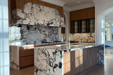 Example of a huge eclectic medium tone wood floor kitchen design in New York with an undermount sink, marble countertops, white backsplash, marble backsplash, paneled appliances, an island and white countertops