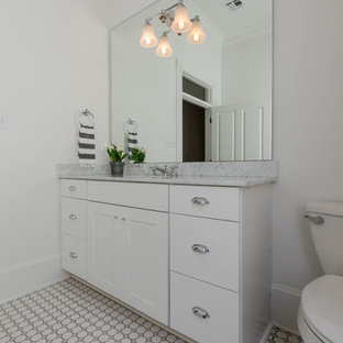 Mid-sized traditional kitchen pantry appliance - Mid-sized elegant l-shaped medium tone wood floor kitchen pantry photo in New Orleans with an undermount sink, raised-panel cabinets, gray cabinets, marble countertops, white backsplash, mosaic tile backsplash, black appliances and an island