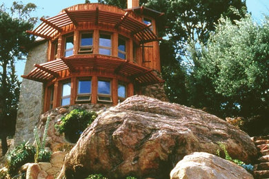 Example of a large mountain style brown two-story mixed siding flat roof design in Santa Barbara