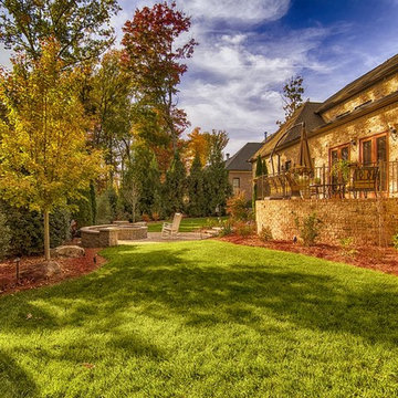 well maintained backyard with patio and fire pit and upper patio