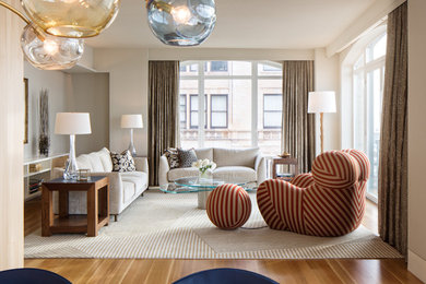 Example of a large minimalist formal and open concept medium tone wood floor living room design in New York with beige walls