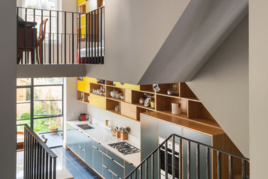 This is an example of a contemporary wood straight staircase in London with wood risers.