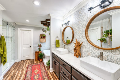 Inspiration for a mid-sized eclectic master multicolored tile and porcelain tile porcelain tile and brown floor bathroom remodel in Other with raised-panel cabinets, black cabinets, a two-piece toilet, gray walls, a vessel sink, quartzite countertops and white countertops