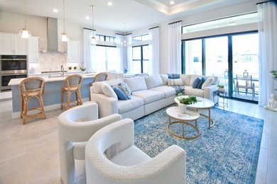 Inspiration for a mid-sized coastal formal and open concept gray floor, tray ceiling and wallpaper living room remodel in Miami with beige walls and a wall-mounted tv