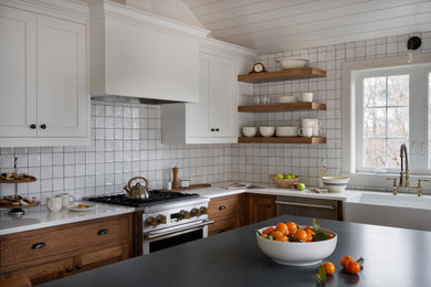 Inspiration for a mid-sized cottage l-shaped light wood floor and shiplap ceiling eat-in kitchen remodel in Boston with a farmhouse sink, beaded inset cabinets, medium tone wood cabinets, quartz countertops, white backsplash, ceramic backsplash, stainless steel appliances, an island and white countertops