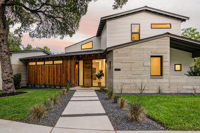 Example of a large danish multicolored two-story mixed siding exterior home design in Austin with a metal roof