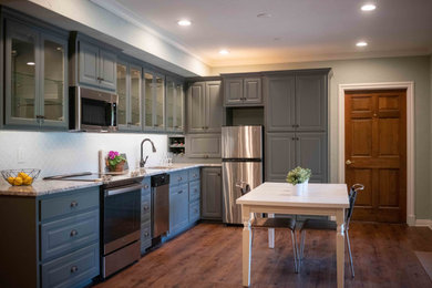 Mid-sized transitional l-shaped vinyl floor and brown floor eat-in kitchen photo in Other with a single-bowl sink, raised-panel cabinets, gray cabinets, granite countertops, white backsplash, ceramic backsplash, stainless steel appliances, no island and beige countertops