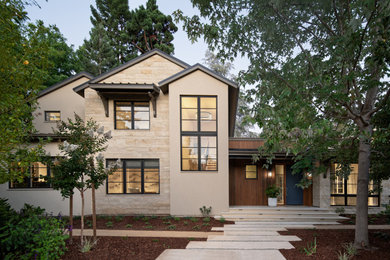 Example of a large transitional beige two-story stone exterior home design in San Francisco with a metal roof and a black roof
