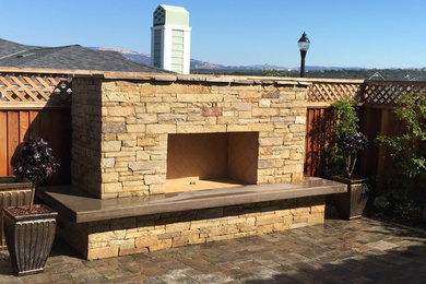 Photo of a mid-sized mediterranean backyard patio in San Francisco with a fire feature, tile and no cover.