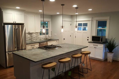 Open concept kitchen - large transitional l-shaped medium tone wood floor open concept kitchen idea in Baltimore with shaker cabinets, white cabinets, an island, soapstone countertops, multicolored backsplash, matchstick tile backsplash and stainless steel appliances