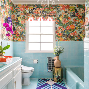 Photo of a world-inspired bathroom in Los Angeles with flat-panel cabinets, white cabinets, an alcove bath, multi-coloured walls, tiled worktops and blue floors.